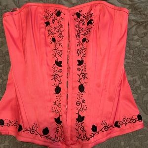 Pink and black laced up corset.